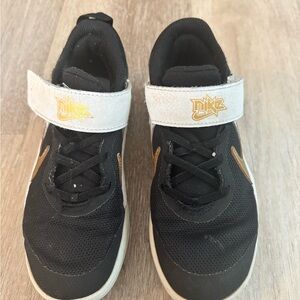 Nike Kids Black Sneakers with Gold Accents